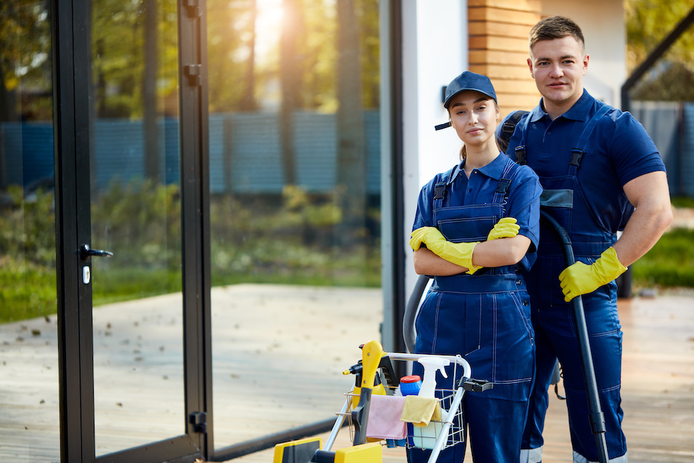 Cheerful team work of two paople from cleaning service